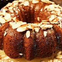 a bundt cake with almonds on top