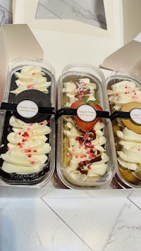 three desserts in a box on a table